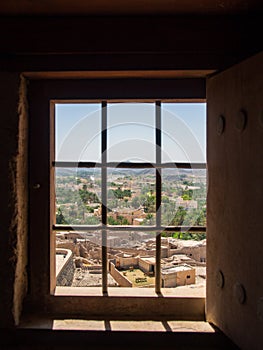 View to the arabic village through window with lattice. Bahla Fort interior.