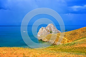 View to Baikal lake with Burkhan cape and Shamanka rock at Olkhon island in approaching thunderstorm. Beautiful summer landscape