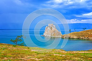 View to Baikal lake with Burkhan cape and Shamanka rock at Olkhon island in approaching thunderstorm. Beautiful summer landscape