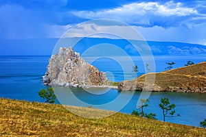 View to Baikal lake with Burkhan cape and Shamanka rock at Olkhon island in approaching thunderstorm. Beautiful summer landscape