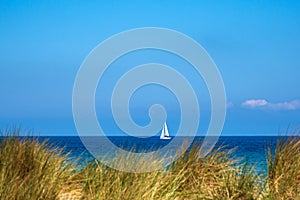 View to the Baltic Sea with sailboat in Warnemuende, Germany