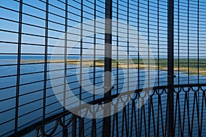 View to the Baltic sea and SÃµrve peninsula through the protective grid  and railings from top of the SÃµrve lighthouse