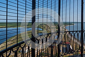 View to the Baltic sea and SÃµrve peninsula through the protective grid  and railings from top of the SÃµrve lighthouse