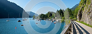 View to campsite lake achensee with sailboats, landscape panorama austria