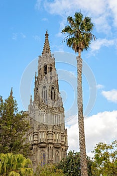 View to the cathedral of San Juan Bautista with palm tree and sky in the backgroundin Arucas