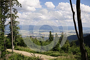 View to the city over the meadow, hills and buildings in the town.