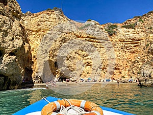 View to coastline with beautiful and sunny portuguese beach next to Ponta da Piedade near Praia do Camilo in summer, Lagos Algarve