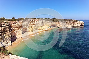 View to coastline with beautiful and sunny portuguese beach Praia da Marinha near Lagoa in summer, Algarve Portugal