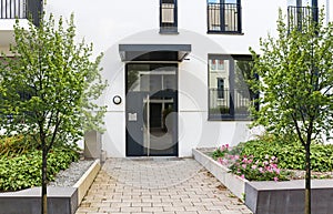 View to entrance door of a modern residential building with new apartments in the city