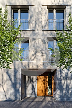 View to entrance door of a modern residential building with new apartments in the city