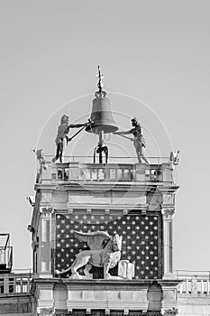 View to famous clock tower with hammering men at St. Mark`s square in Venice, Italy