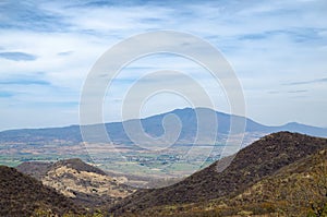 View to the green valley, dry forest hills and mountains at the