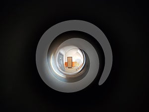 View to the hall through peephole eyelet in the door. 