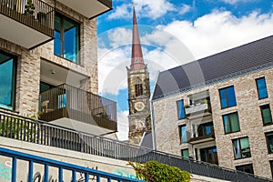 View to historical church `Stephanie` between new modern buildings with flats next to river Weser and `Weserpromenade` in Bremen