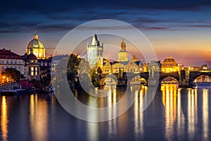 View to the illuminated Charles Bridge and Old Town of Prague, Czech Republic, during night time