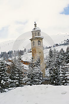 View to the inclining bell tower at the ski resort town of St. Moritz, Engadine valley, Switzerland.