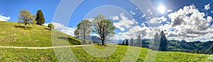 View to Inntal and Wilder Kaiser mountain range in the Alps, Building land for new construction project on green sunny meadow, photo