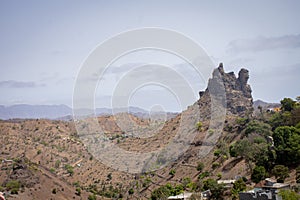 View to a lonely village with simple stone houses in a valley in the mountains in the center of Santiago Island,