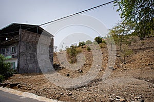 View to a lonely village with simple stone houses in a valley in the mountains in the center of Santiago Island,