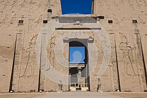 View to the main entrance of an Ancient Egyptian Edfu Temple showing the first pylon in the Sunny Day