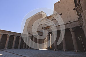 View to the main entrance of an Ancient Egyptian Edfu Temple showing the first pylon in the Sunny Day