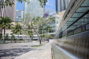 View to the Menara Tower or KL tower through the palm trees of the KLCC park