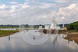 View to the Monastery on Taungthaman Lakereflected in the water from U-bein bridge near Amarapura in Myanmar Burma.