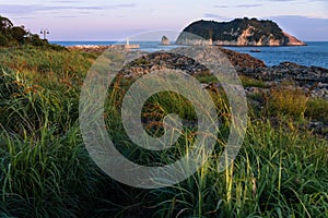 View to Moon Island and Lighthouse during sunset at Seaseom, Seogwipo, Jeju Island, South Korea