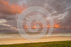 View to the ocean at sunrise. Some of the clouds are illuminated by the sun. North Holland dune reserve, Egmond aan Zee,