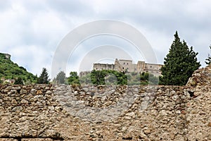 View to old stone wall and Despot palace in abandoned medieval town Mystras, Greece