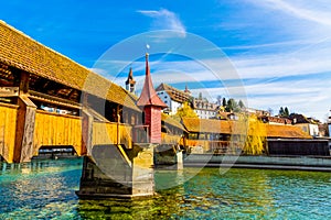 View to the old town buildings and wooden bridge over Reuss river in Lucerne, Switzerland