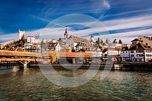 View to the old town buildings and wooden bridge over Reuss river in Lucerne, Switzerland