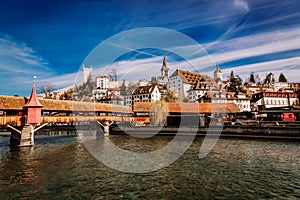 View to the old town buildings and wooden bridge over Reuss river in Lucerne, Switzerland