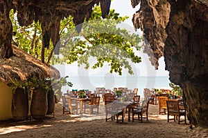 View to open-air restaurant on beach from cave