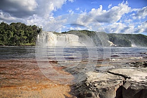 View to a powerful waterfall on a sunny bright day