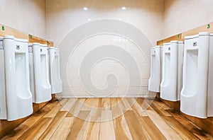 View to public toilet with white urinals man