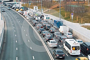 A view to a road with plenty of cars standing at traffic jam on