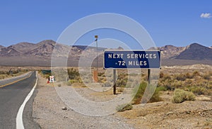 View to the road and sign at Shoshone, USA