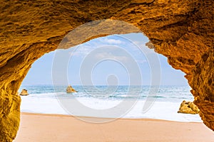 View to the sea beach from inside a cave