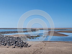 View to the sea from Northam Burrows, north Devon, UK. Tide out. Waves and seashore just about visible in the distance Dramatic