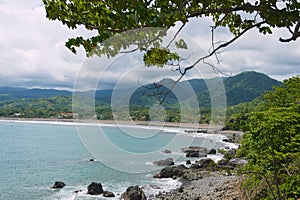 View to the seaside with the black volcanic lava beach in Jaco, Costa Rica. photo