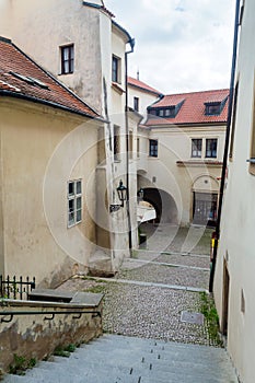View to the small street in courtyard with houses in the old center of Prague