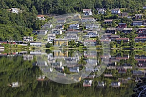 View to the small town Norheimsund. The houses are reflected in the calm water photo