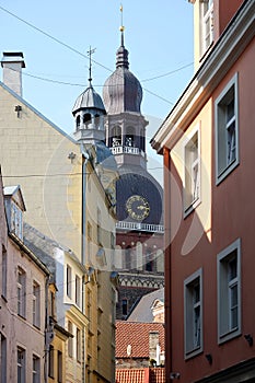 View to sprire Dome Cathedral from dense standing houses of old town Riga
