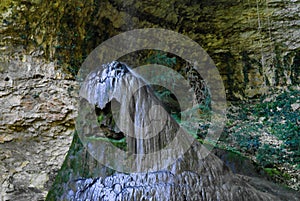 View to stalagmite under the Shakuran waterfall in Abkhazia, Georgia