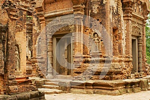 View to the stone carving at the walls of the ruins of the Preah Ko Temple in Siem Reap, Cambodia.