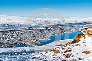 View to Tromso city in Norway from Storsteinen peak on a sunny winter day