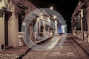 View to typical street with one story buildings at night in light of lanterns, Santa Cruz de Mompox, Colombia, World Heritage