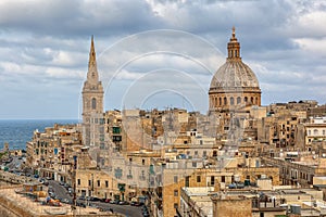 View to Valetta city buildings under clouds