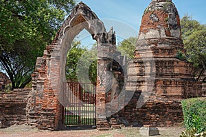 View to the wall and door into stupa and ruins of temple, old Siam capital Ayutthaya,the historical about religious architecture o